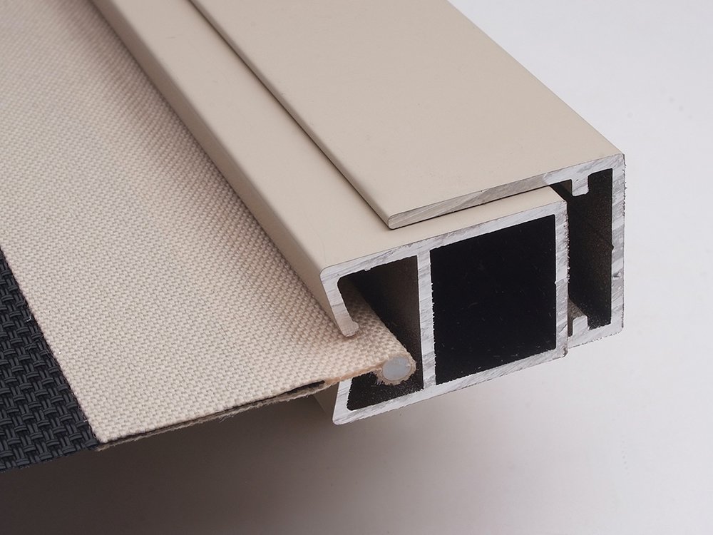 Cutaway of a Ziptrak side channel with the fabric edge captured inside the aluminium profile