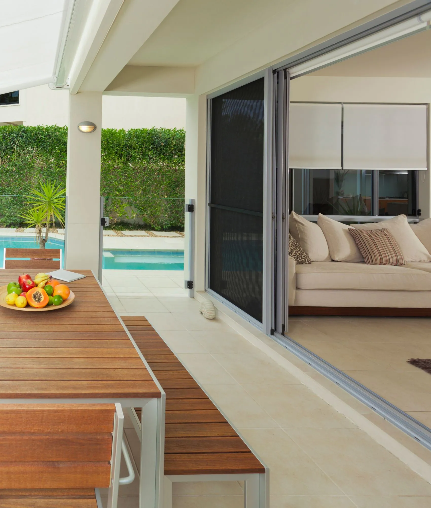 Security doors and windows beside a pool deck