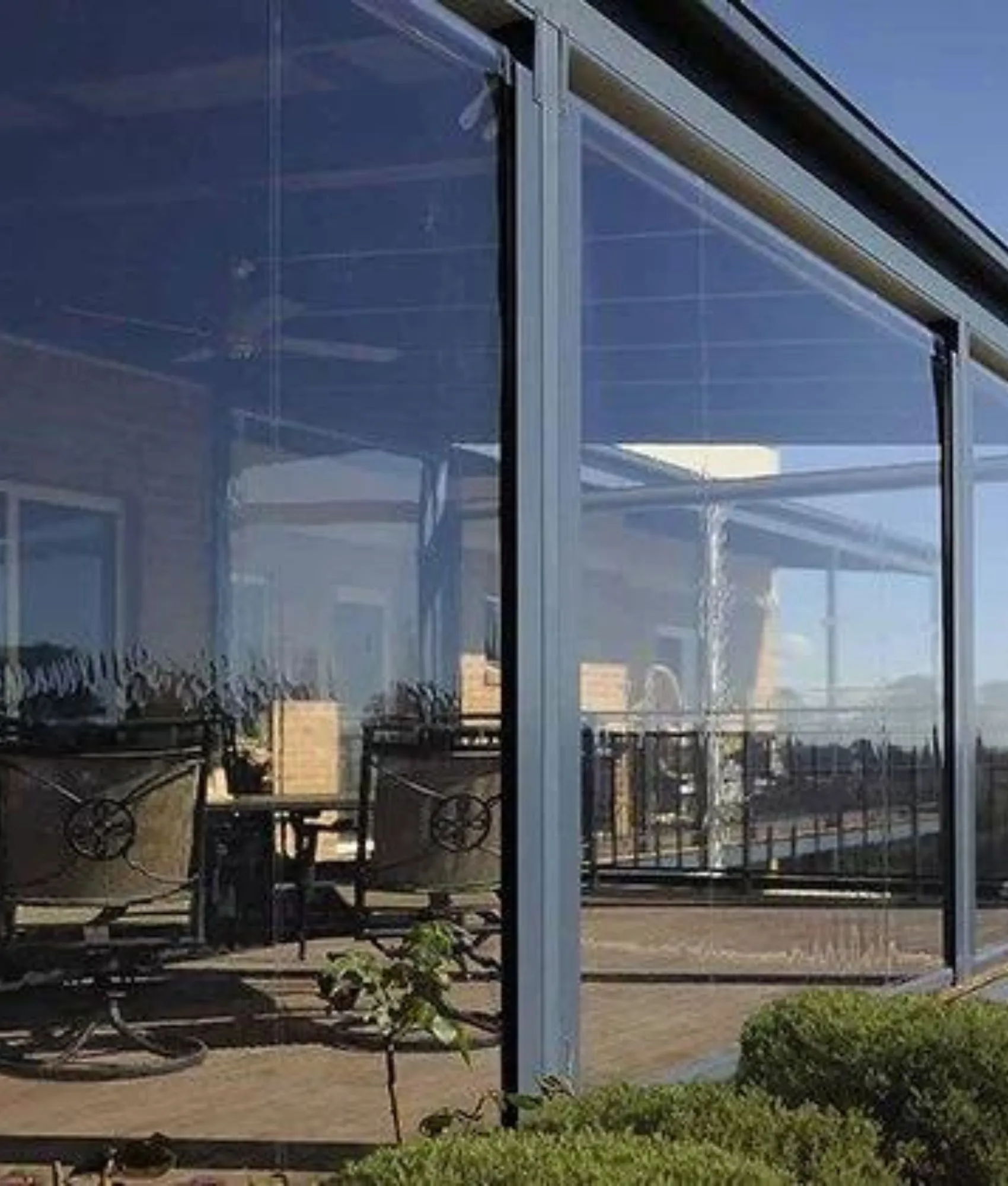 Clear zip roll up blinds enclosing a verandah