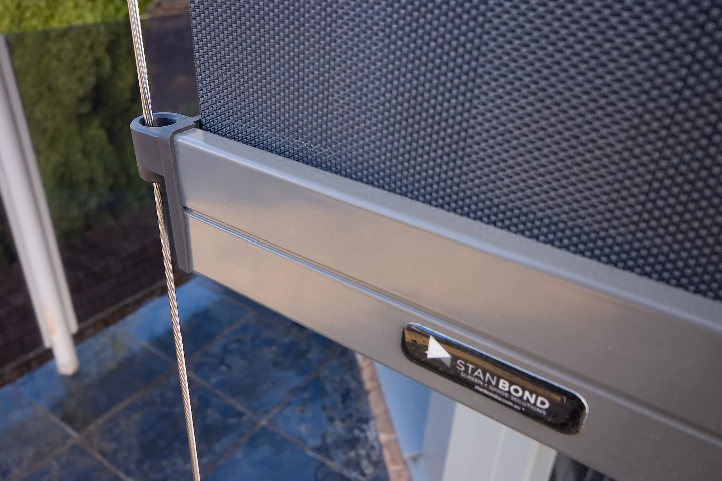 Bottom bar of a wire guided blind with its guide wire through the end cap and a Stan Bond badge