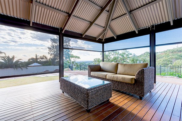 Outdoor alfresco area enclosed with outdoor blinds, lounge setting with a view over the hills
