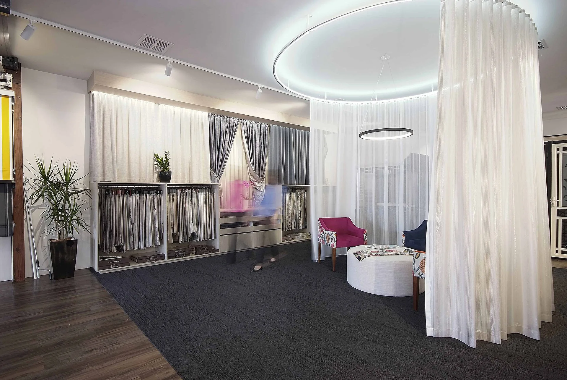 Inside the Stan Bond showroom at Campbelltown: curtain and sheer displays, fabric racks and a seating area