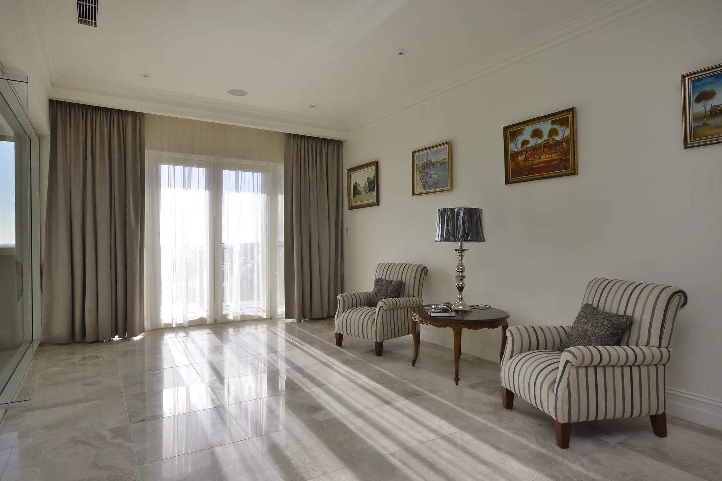 Formal sitting room with pleated drapes framing French doors