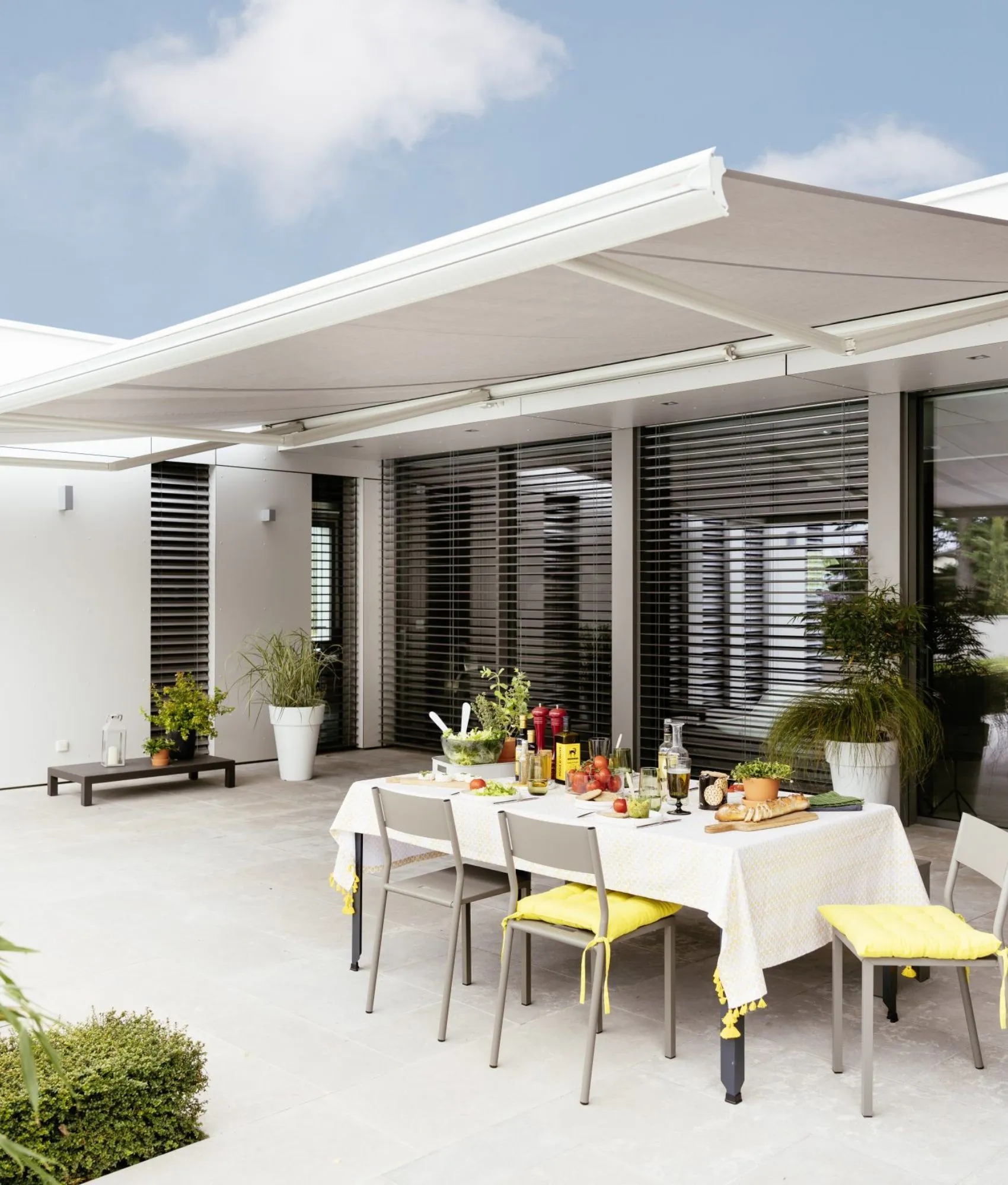 Motorised outdoor awning over an alfresco dining table