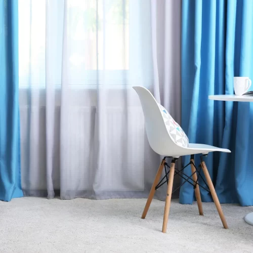 Blue curtains layered over white sheers
