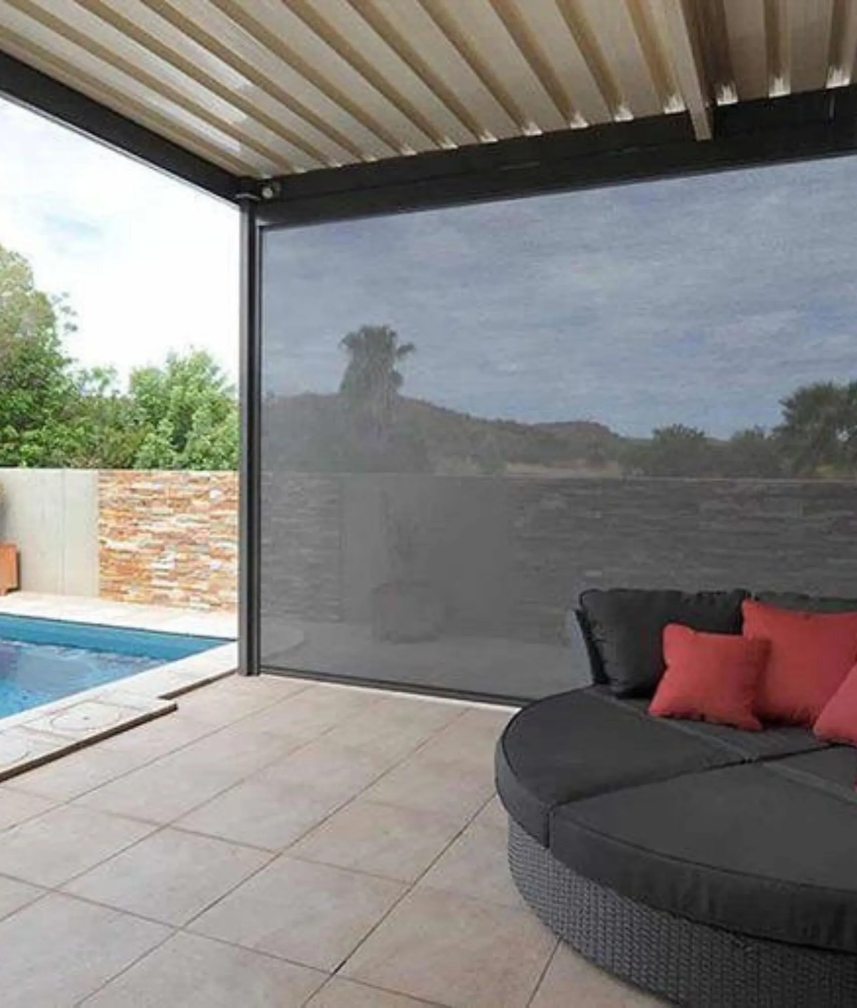 Zipscreen blind under a louvred roof beside a pool