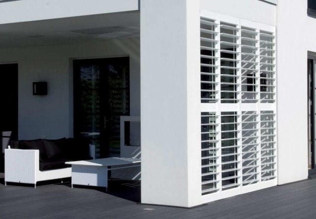 White aluminium shutters on an outdoor terrace