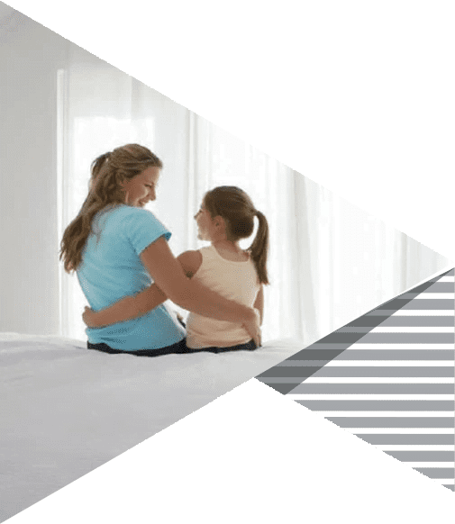 A mother and daughter sitting together in a bright room