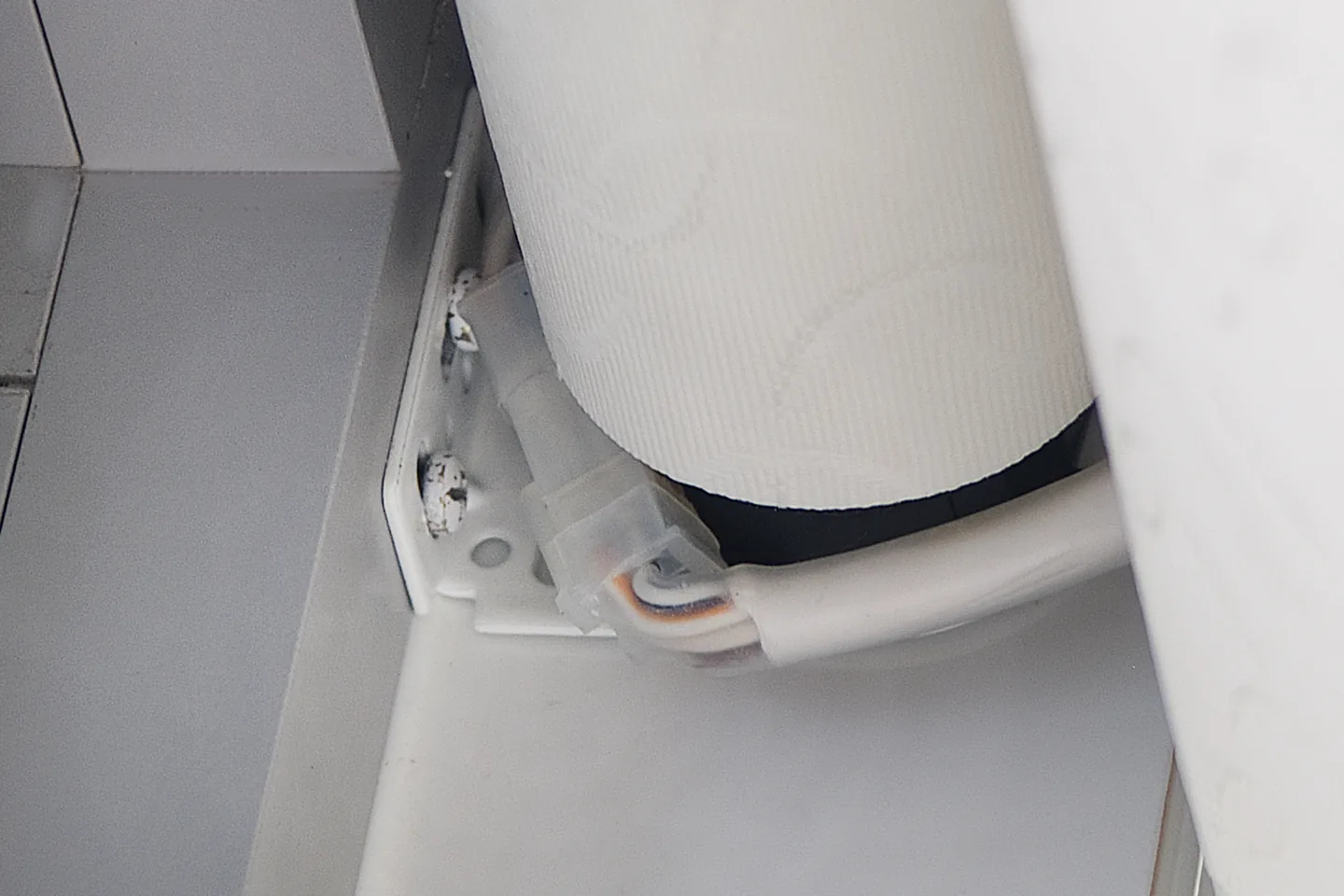 Close view of a roller blind tube seated in its white end bracket