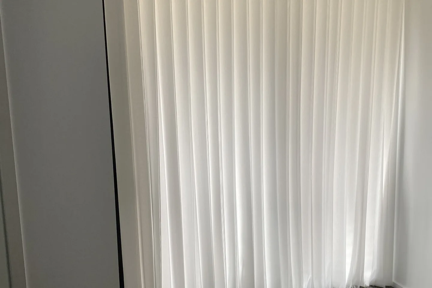 White Veri Shades closed into a soft continuous sheer across a doorway