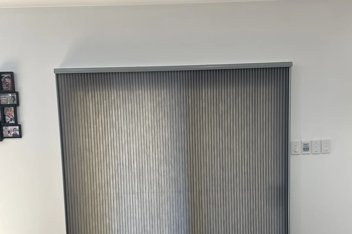Grey Veri Shades closed over a sliding door in a timber-floored room