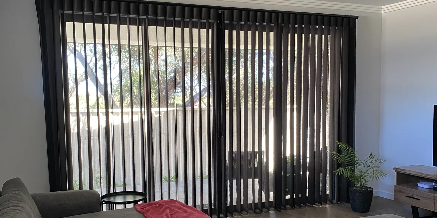 Living room with charcoal Veri Shades drawn across a wide sliding door