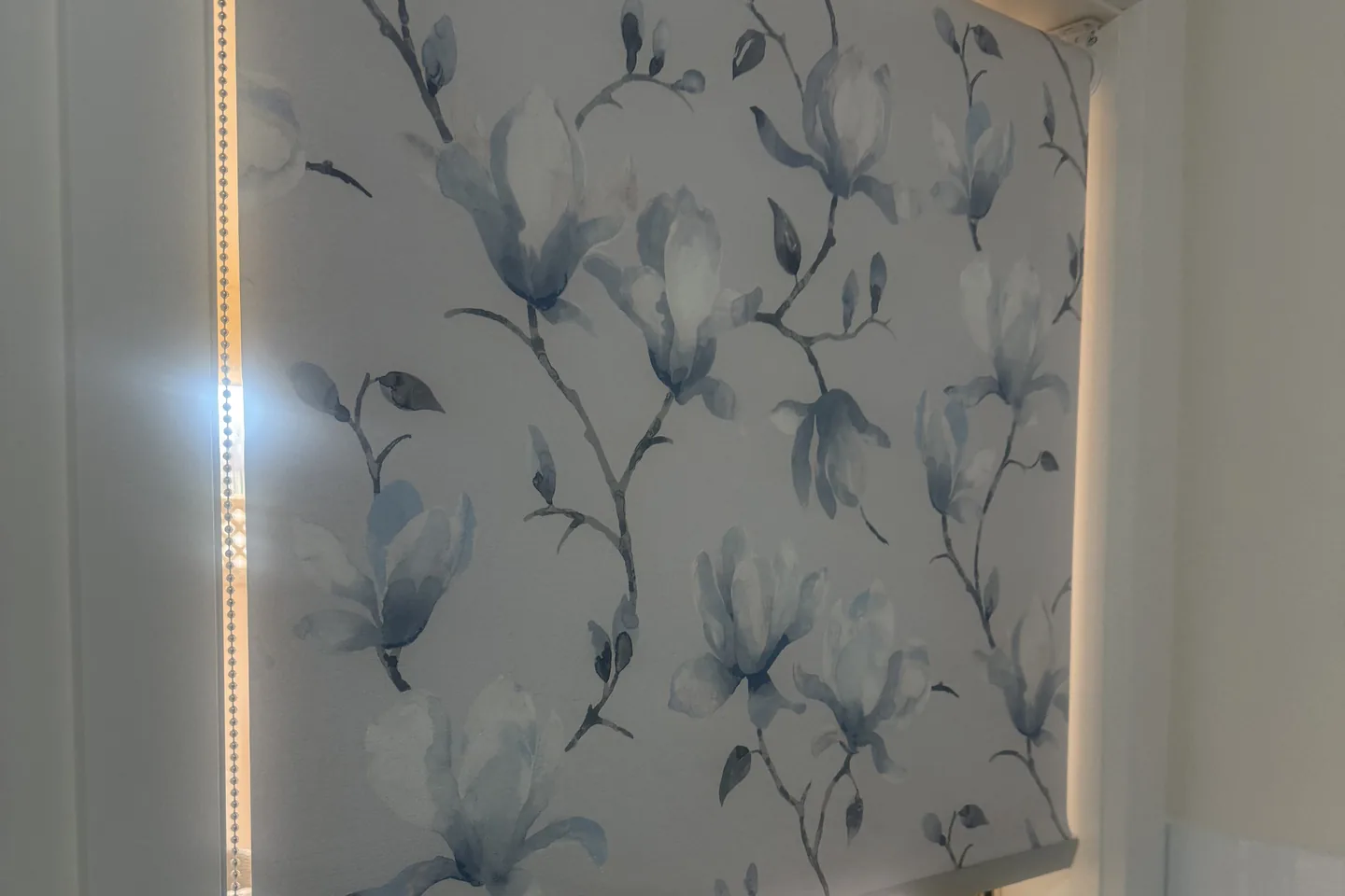 Floral print Ziptrak Interior blind lowered over a bathroom window