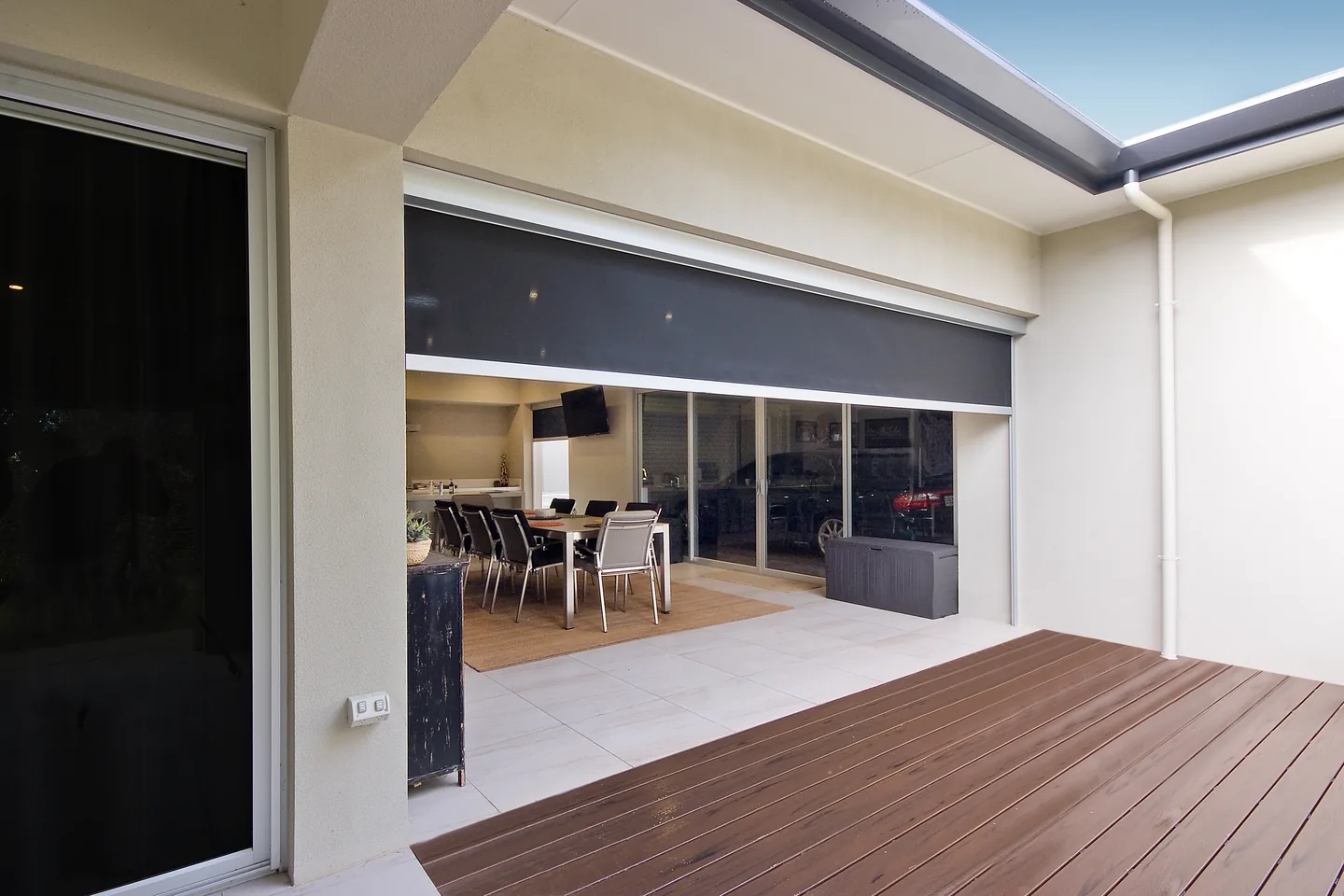 The same alfresco opening with the blind raised most of the way, showing the dining area inside