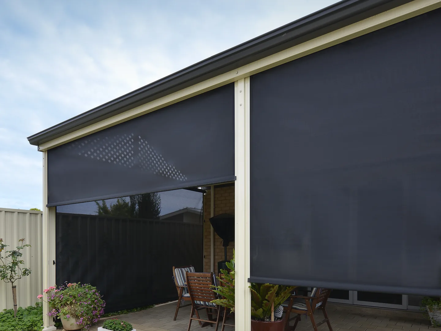 Patio with the right-hand outdoor blind lowered close to the paving
