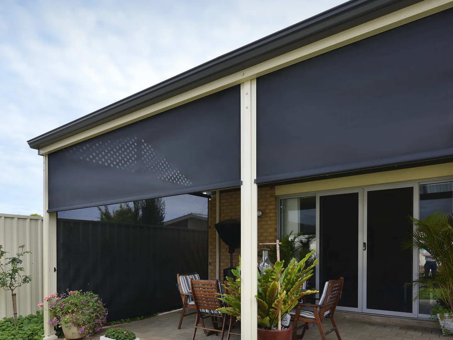 The same patio with the right-hand outdoor blind raised, showing the sliding door behind